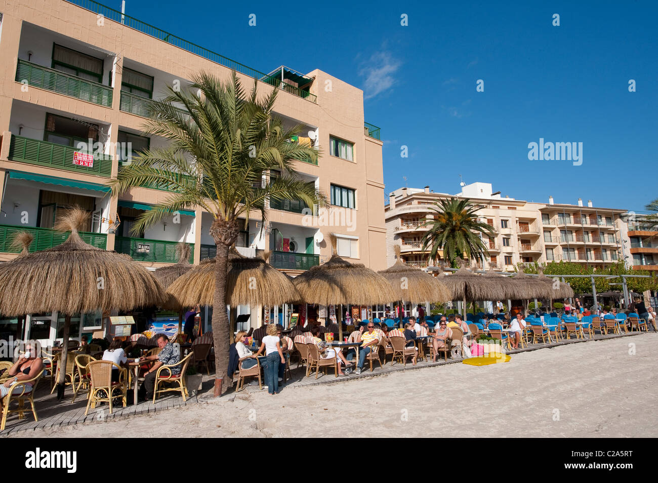Holidaymakers enjoying outdoor dining outside a bar / restaurant in