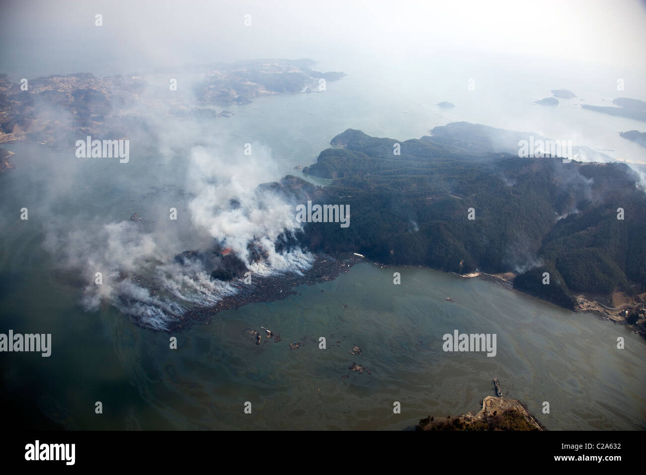 Aerial view of fire and damage to Kesennuma, Miyagi Prefecture after a 9. 0 magnitude earthquake and subsequent tsunami Stock Photo