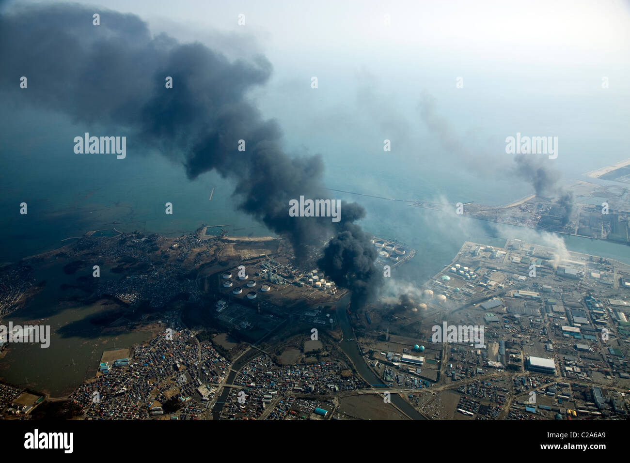Aerial view of fire at industrial complex and damage in Sendai Shiogama Port, Sendai, Miyagi Prefecture after a 9. 0 magnitude Stock Photo