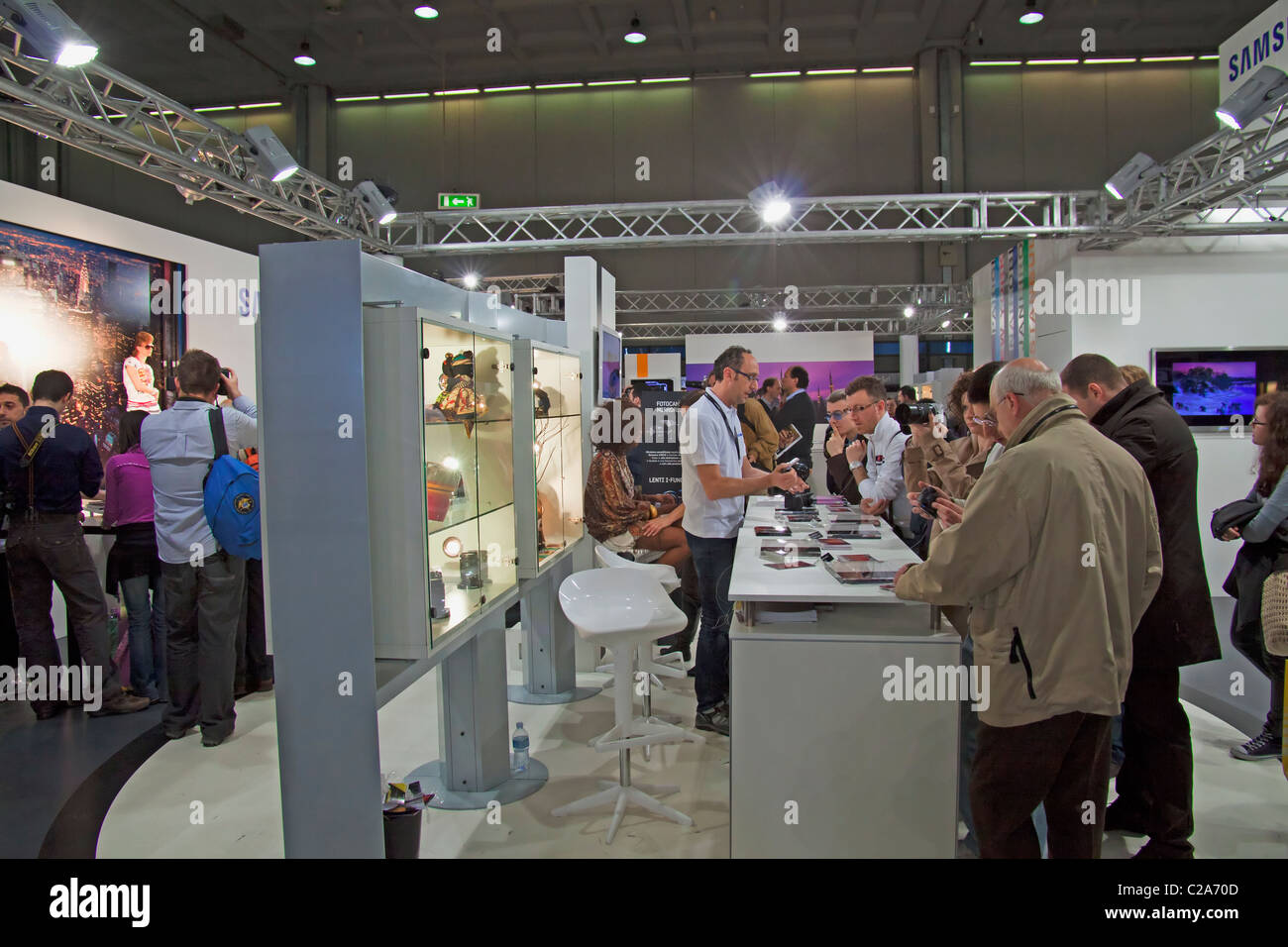 MILANO, ITALY - MARCH 27: People trying lenses in Canon stand at international photographic Fair 'Photoshow' in Milan (25-28 Mar Stock Photo