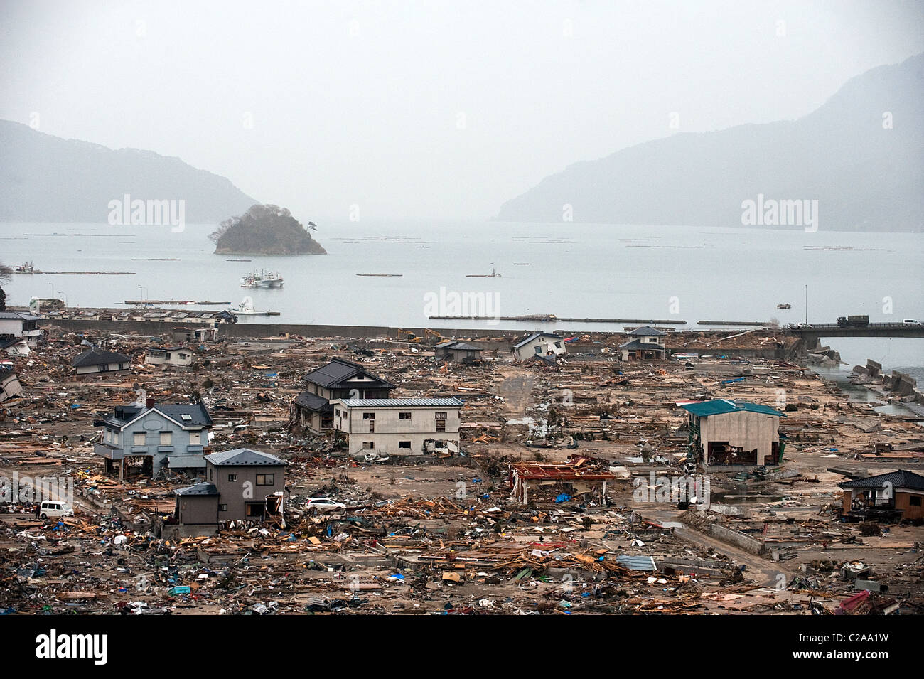 Fishing boats, cars and houses were completely destroyed after a 9.0 Mw earthquake triggered a Tsunami in the town of Otuchi, Stock Photo