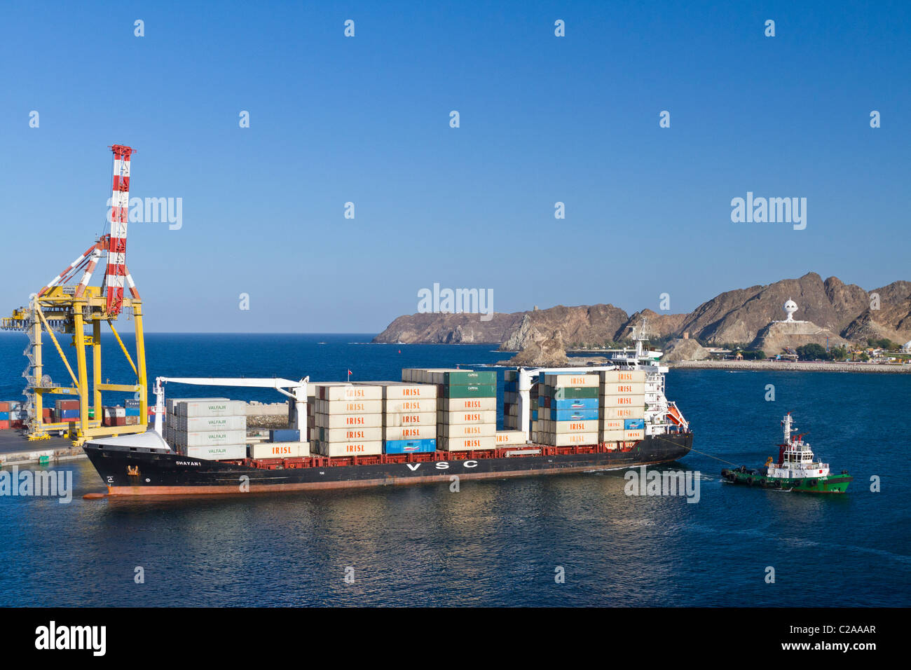 A loaded container ship entering Port Sultan Qaboos in Muscat Oman. Stock Photo