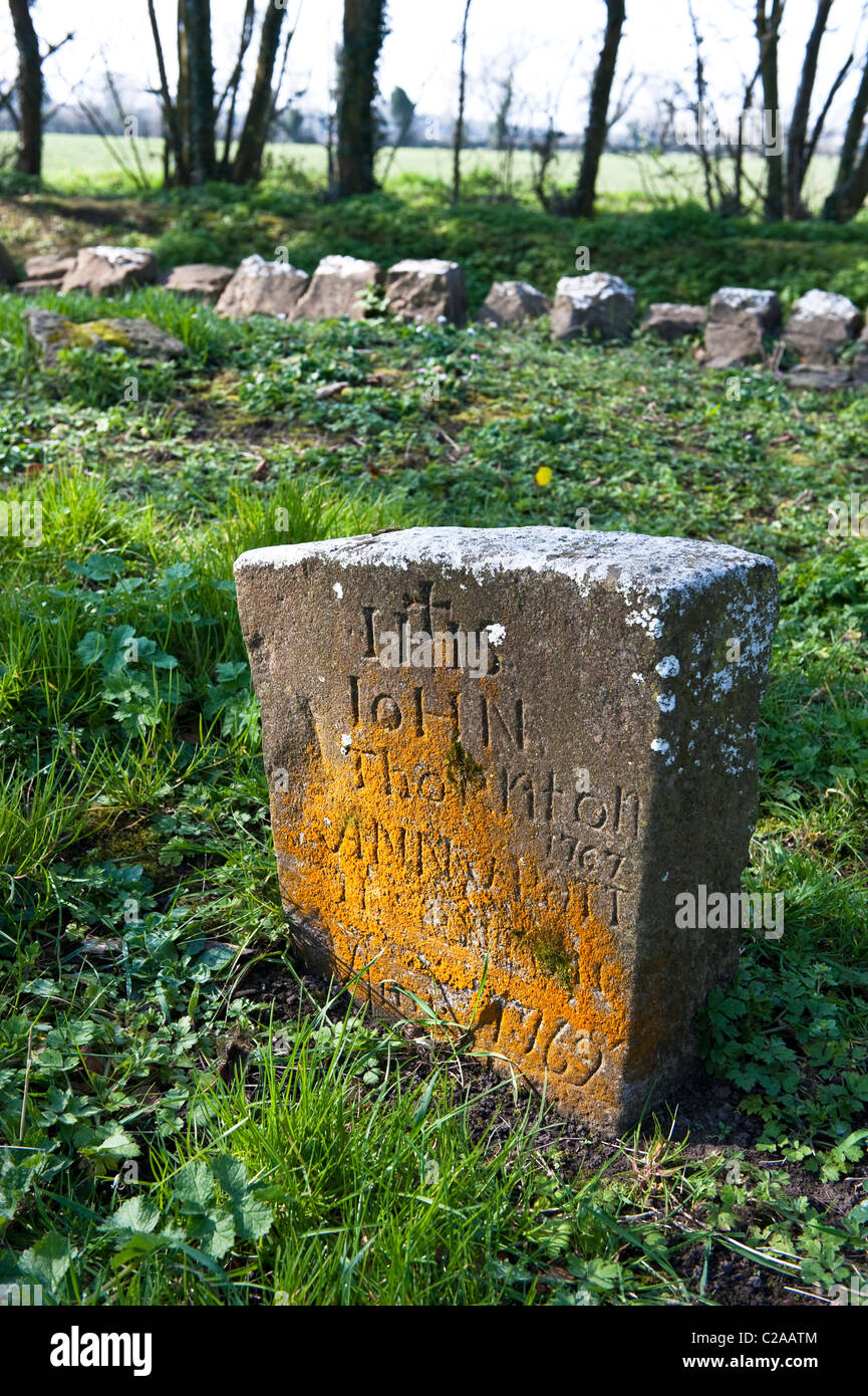 A gravestone from the 1700's in Saint Mobhi's medieval cemetery, in the countryside near Skerries, Co Dublin, Ireland, Stock Photo