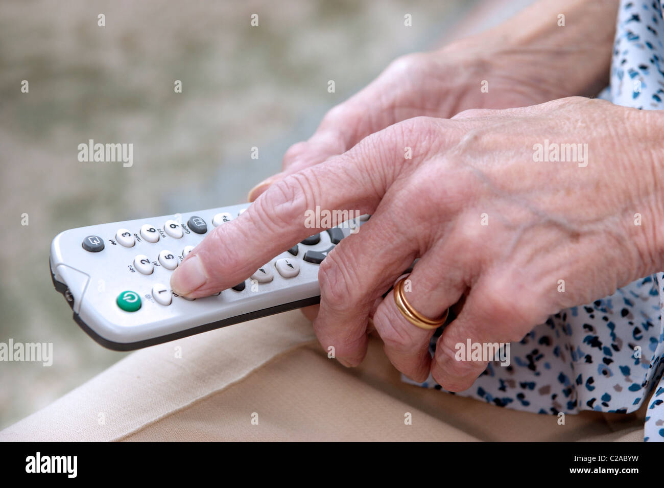 elderly woman using a television remote control Stock Photo Alamy