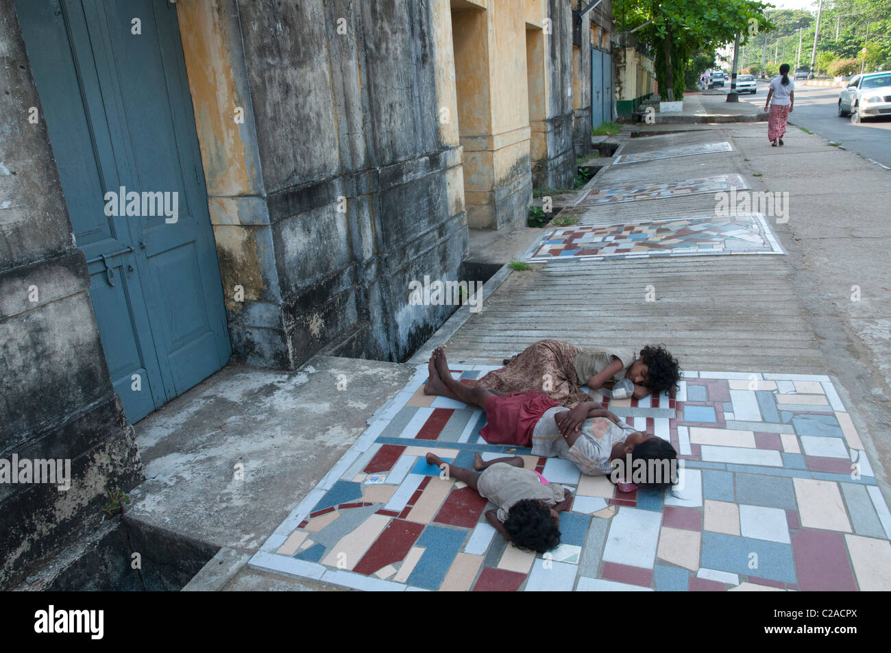 Homeless children sleeping rough on the pavement. yangon. Myanmar Stock Photo