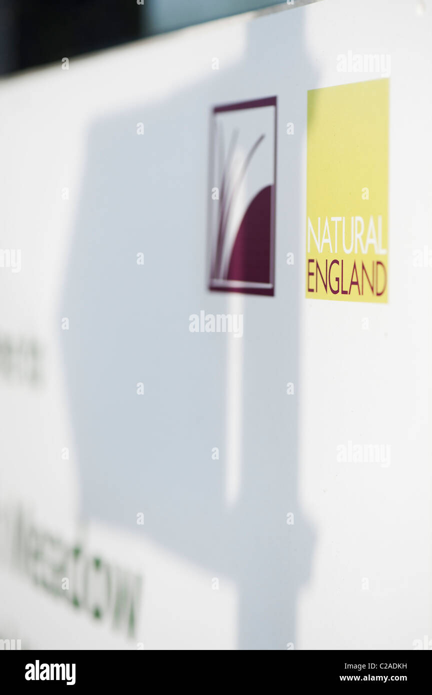 Natural England signpost with directional signpost shadow Stock Photo
