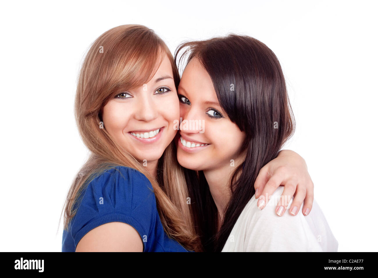 two happy young women standing, smiling - isolated on white Stock Photo ...
