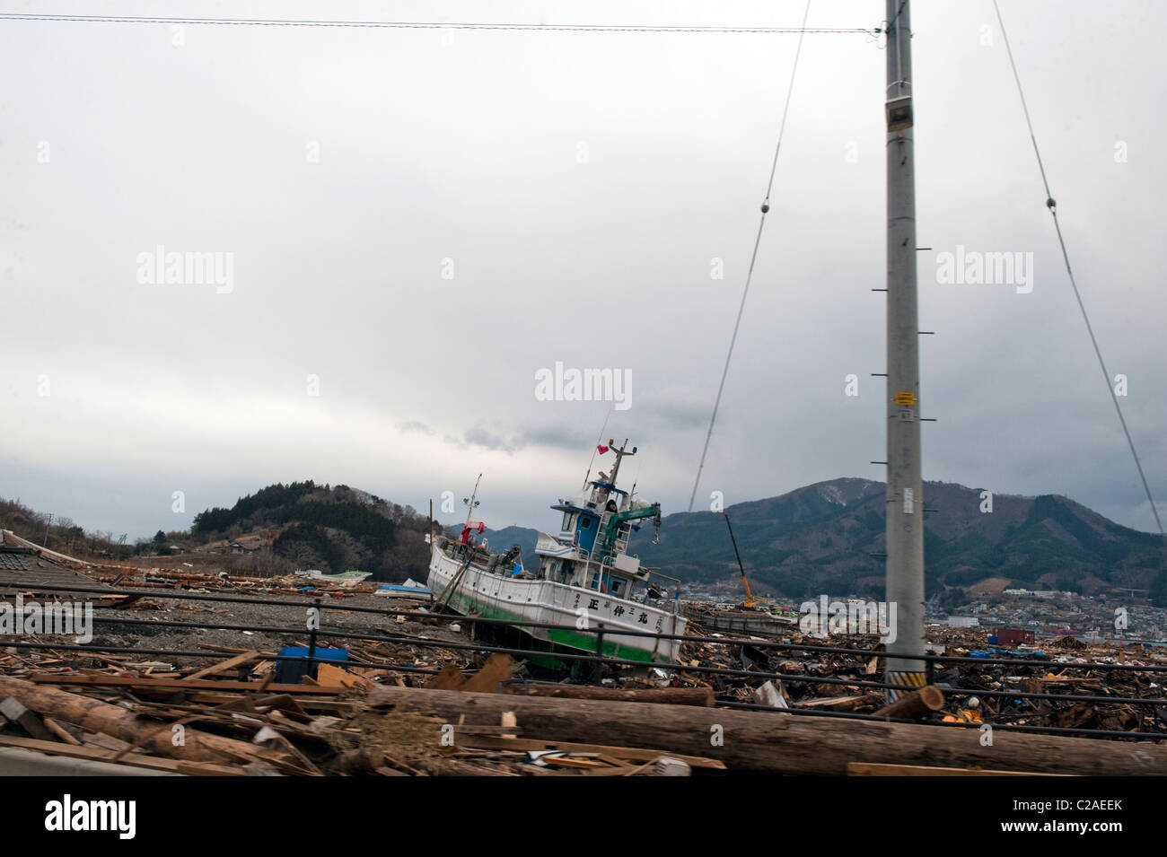 Fishing boat miles from the coast after a 9.0 Mw earthquake triggered a Tsunami destroying large parts of Ofunato, Japan 2011 Stock Photo