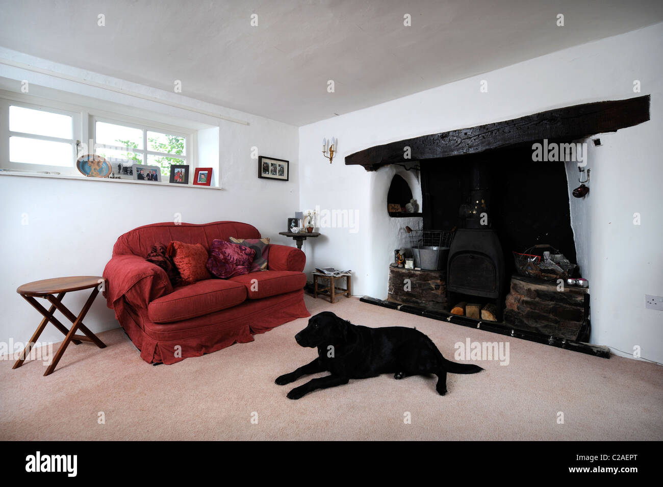 Traditional cottage living room with an inglenook fireplace UK Stock Photo