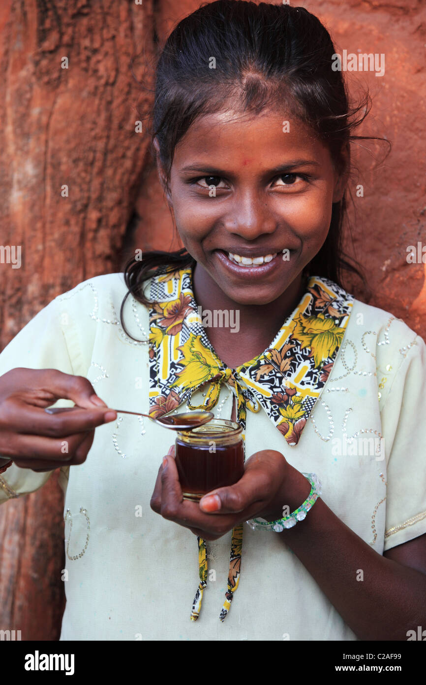 Indian girl eating honey Andhra Pradesh South India Stock Photo - Alamy