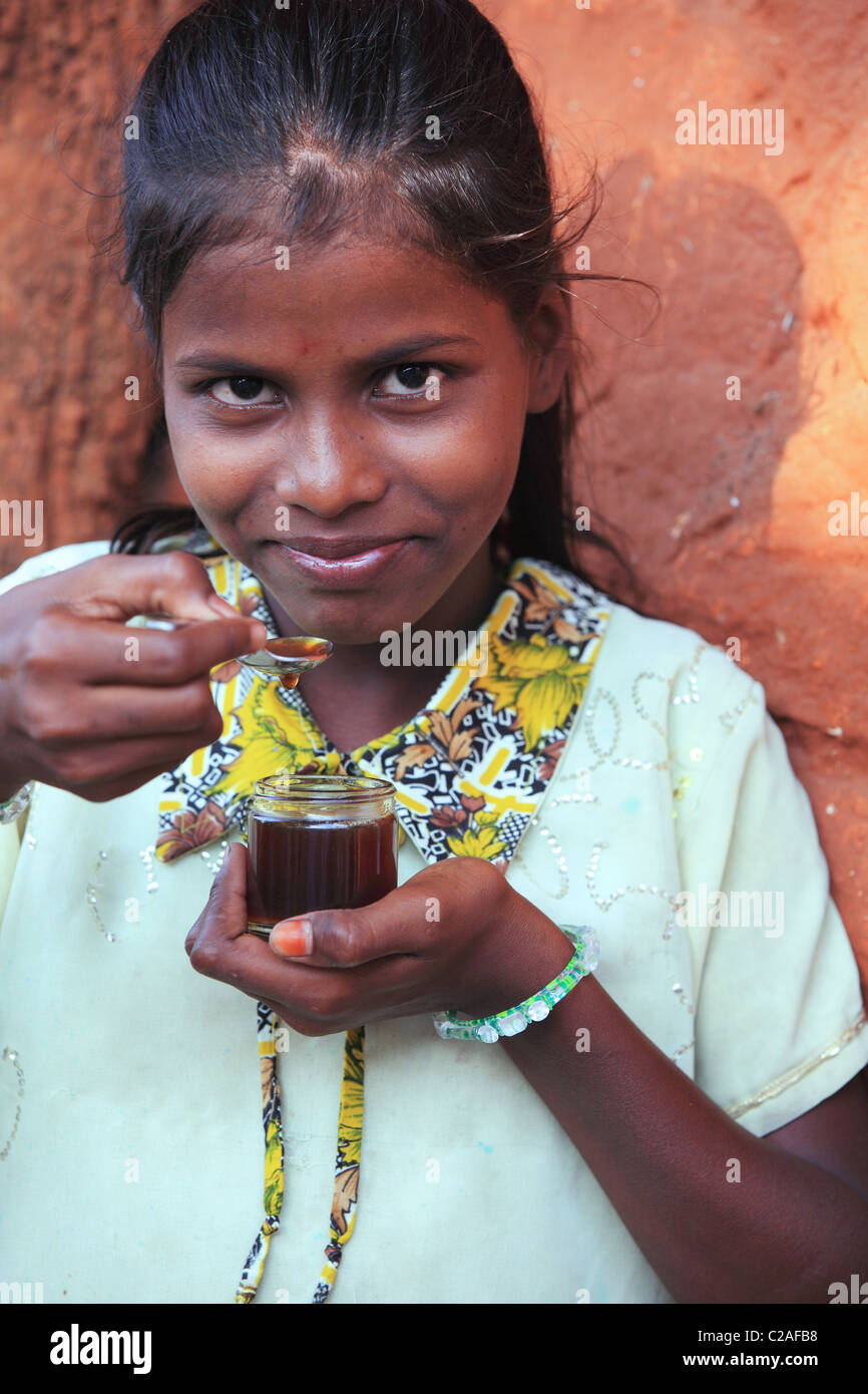 Indian girl eating honey Andhra Pradesh South India Stock Photo - Alamy