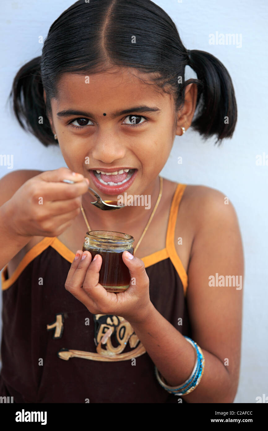 Indian girl eating honey Andhra Pradesh South India Stock Photo - Alamy