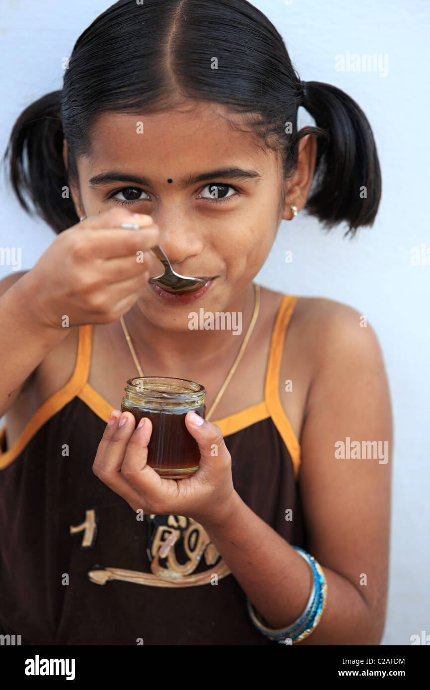 Indian girl eating honey Andhra Pradesh South India Stock Photo - Alamy