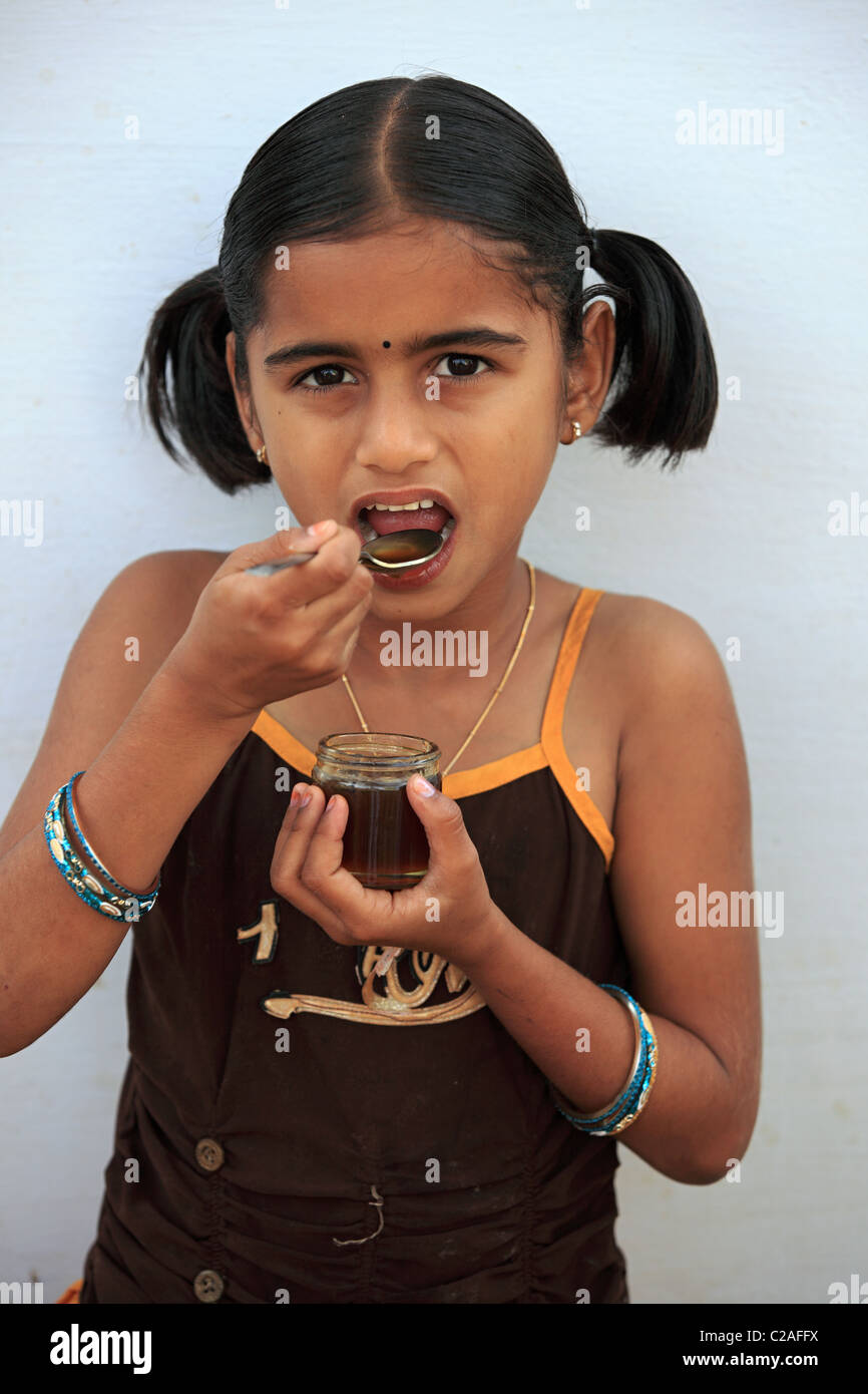 Indian girl eating honey Andhra Pradesh South India Stock Photo - Alamy
