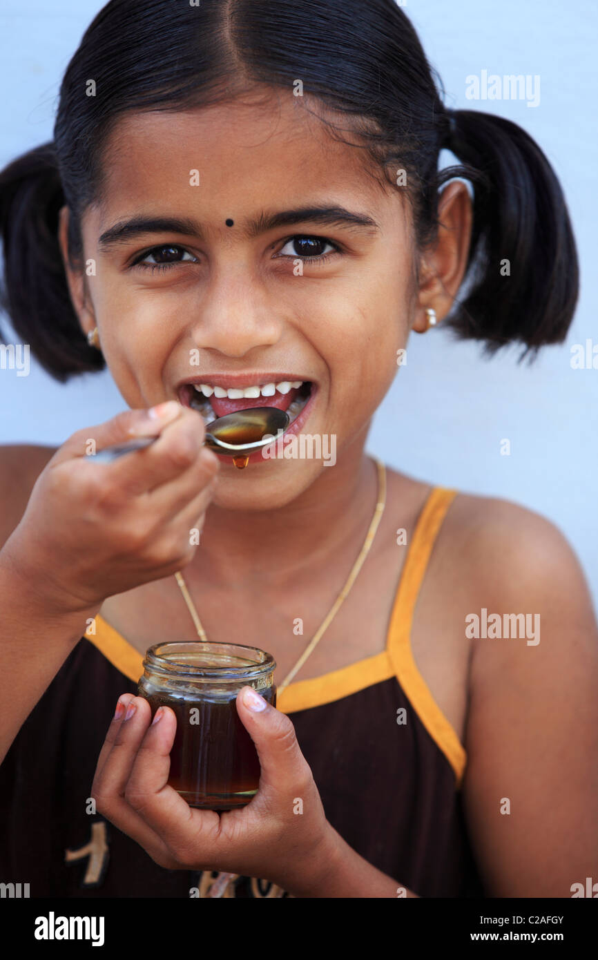 Indian girl eating honey Andhra Pradesh South India Stock Photo - Alamy
