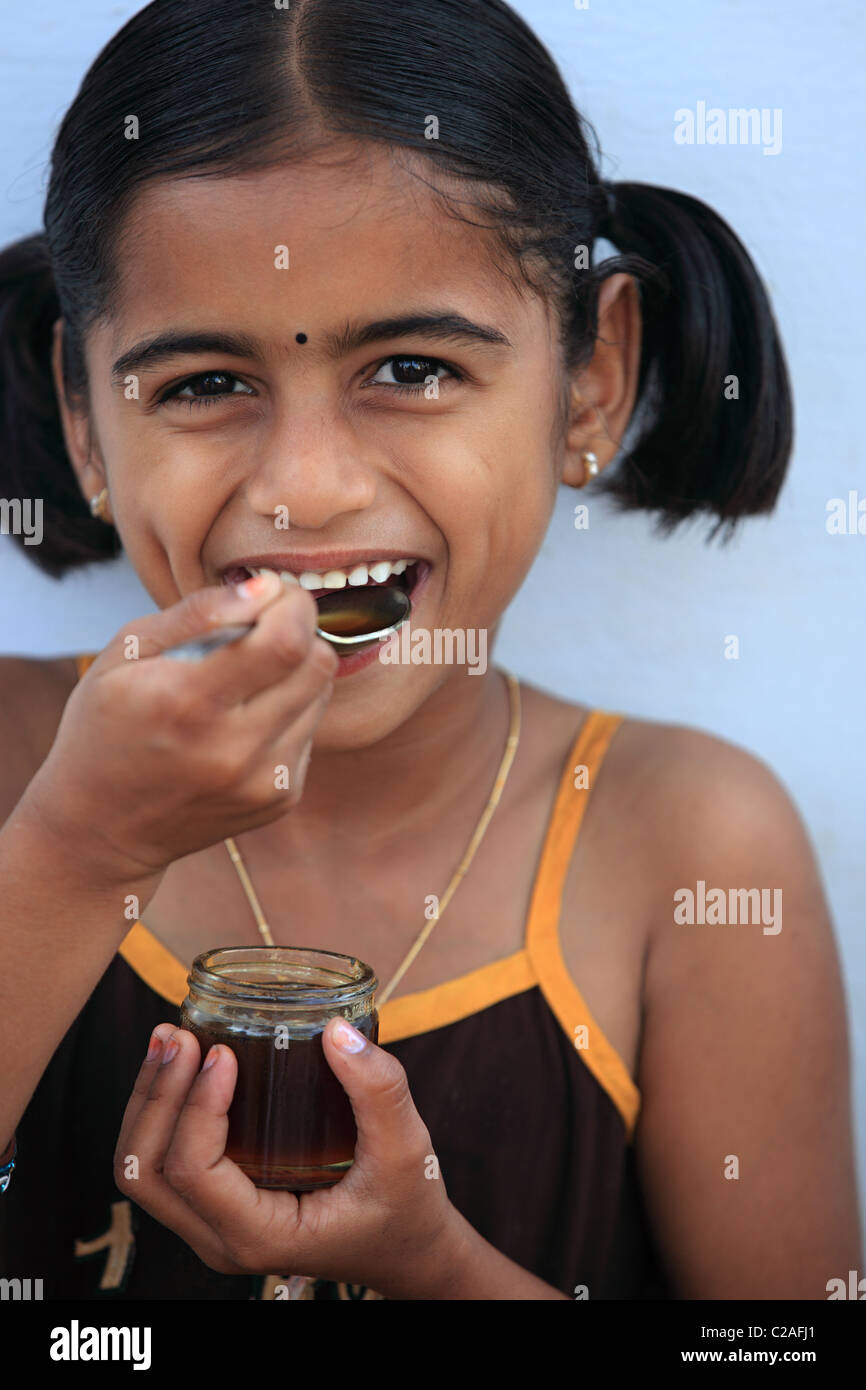 Indian girl eating honey Andhra Pradesh South India Stock Photo - Alamy