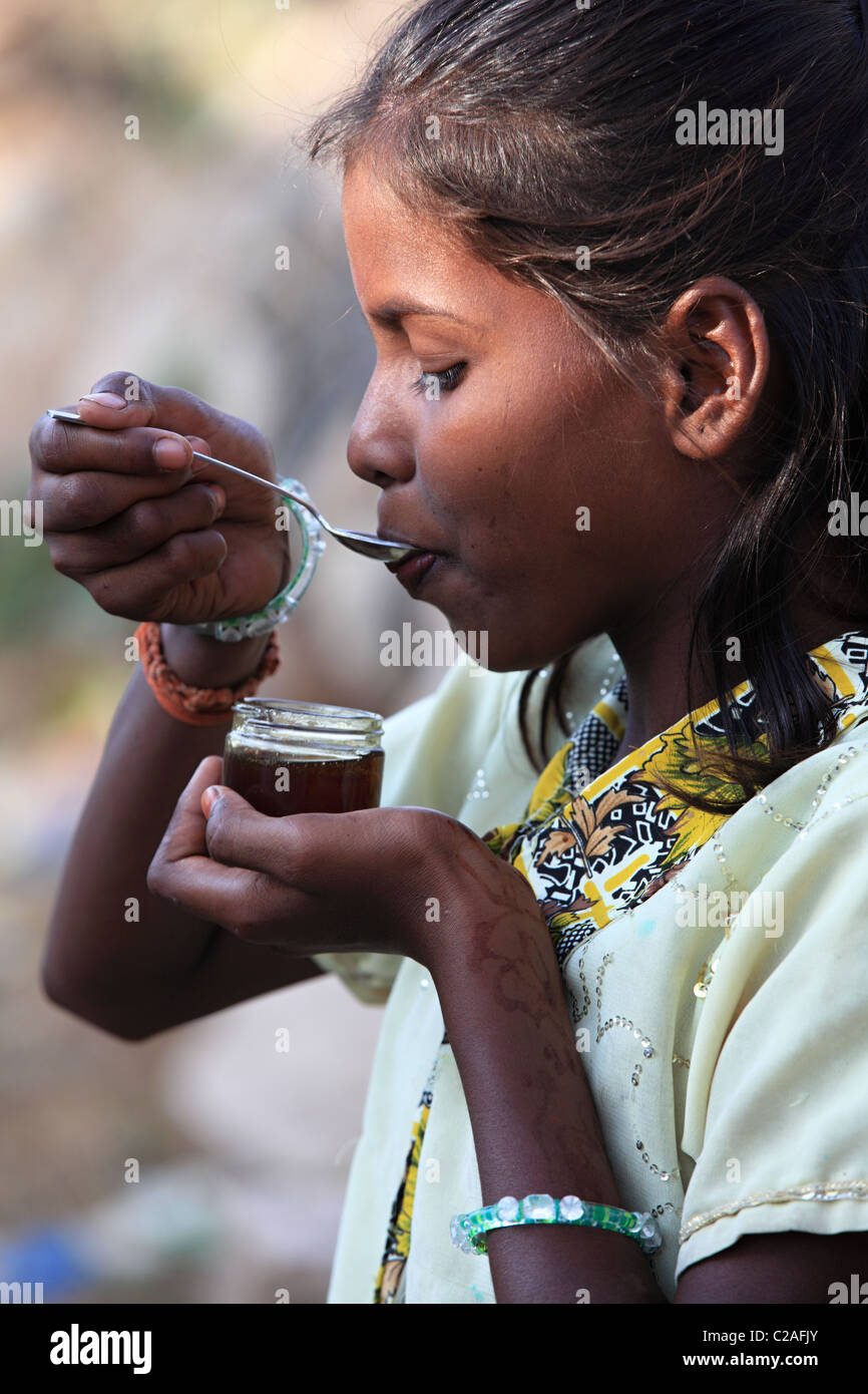 Indian girl eating honey Andhra Pradesh South India Stock Photo - Alamy