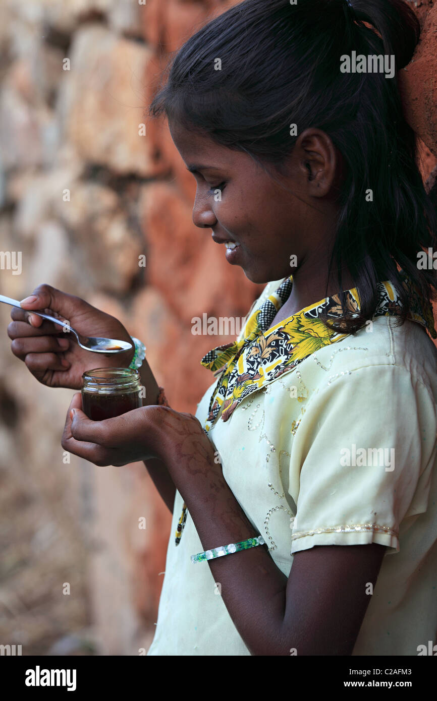 Indian girl eating honey Andhra Pradesh South India Stock Photo - Alamy