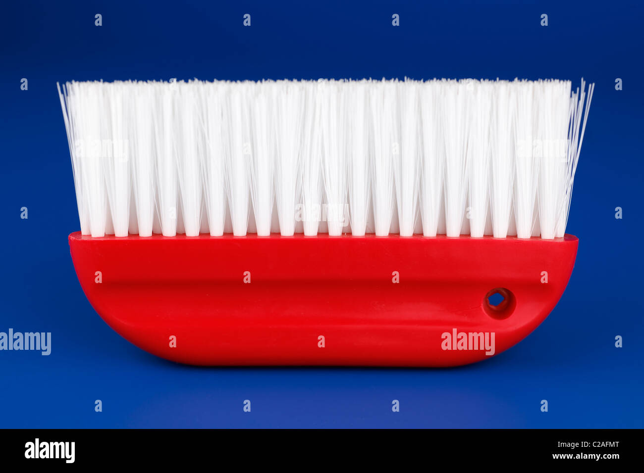 Red decorators wallpaper smoothing brush Stock Photo - Alamy