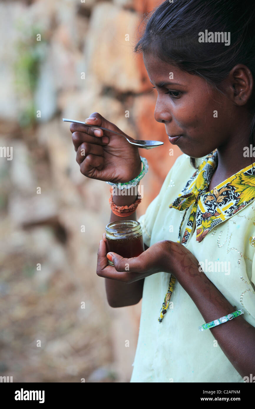 Indian girl eating honey Andhra Pradesh South India Stock Photo - Alamy