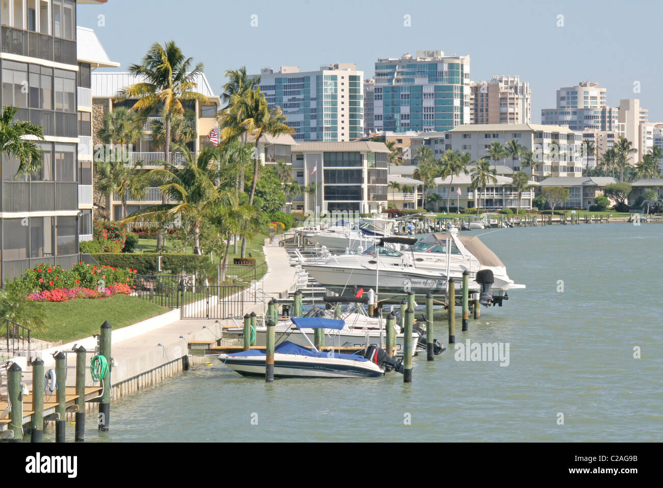 Boats and condominium buildings on canal, Naples Florida Stock Photo