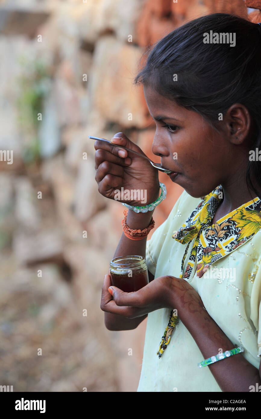 Indian girl eating honey Andhra Pradesh South India Stock Photo - Alamy
