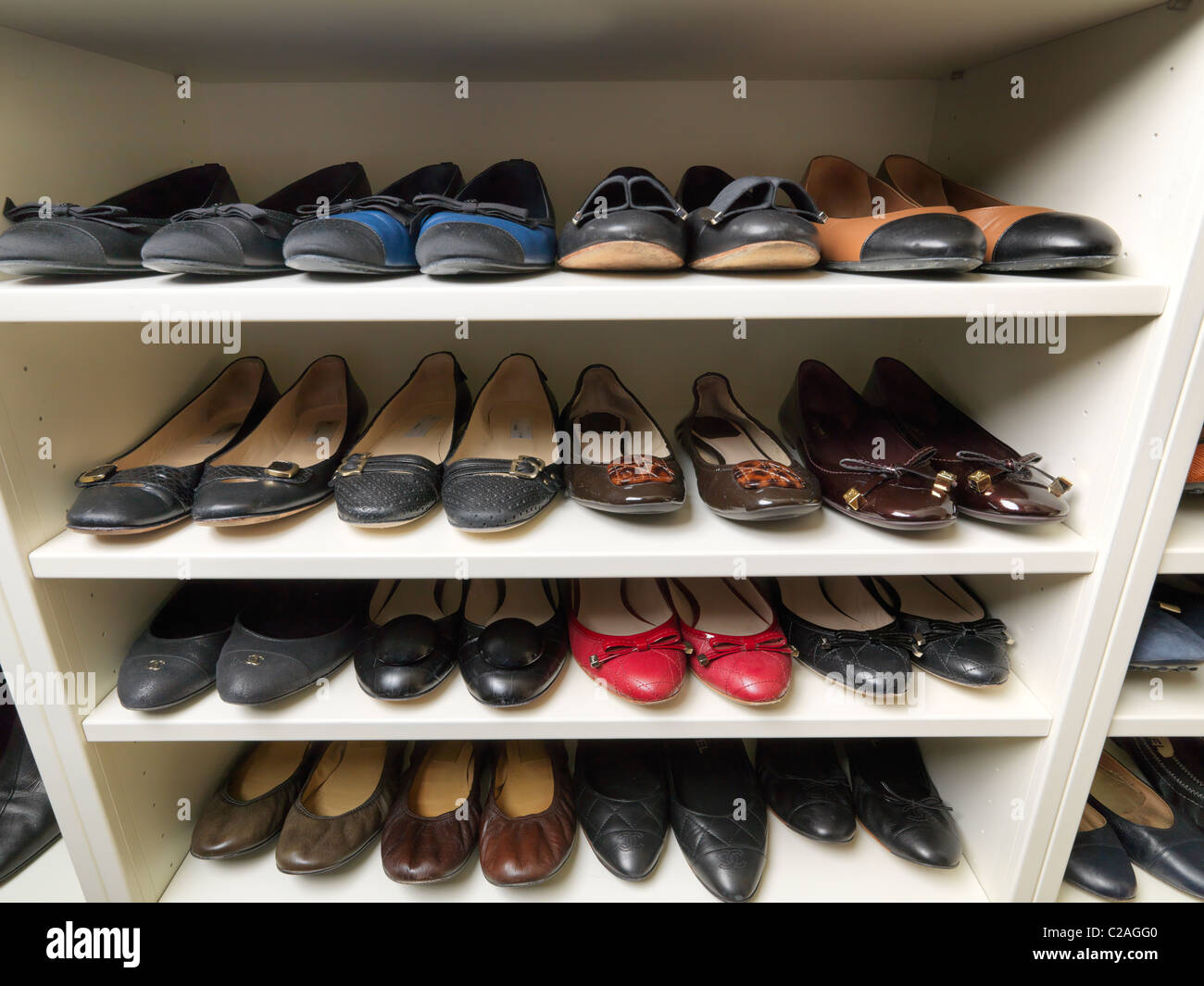 Shoe storage designed and photographed by Tim Wood for over two hundred and fifty pairs of top brand shoes in a walk in closet Stock Photo