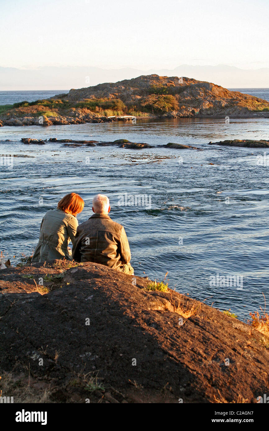 Couple watching sunset Lopez Island San Juan Islands Washington Stock Photo