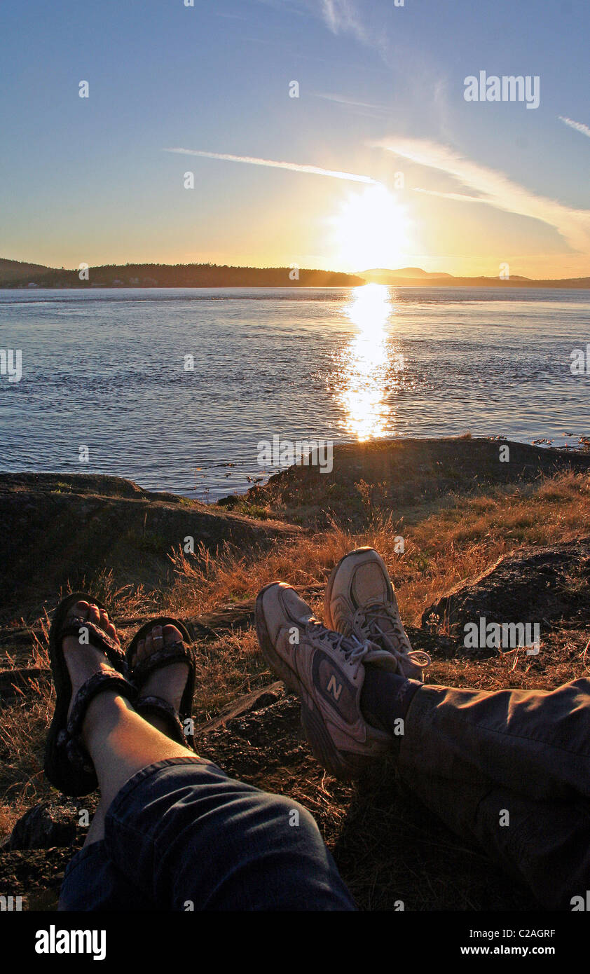 Feet of couple and sunset Lopez Island San Juan Islands Washington Stock Photo
