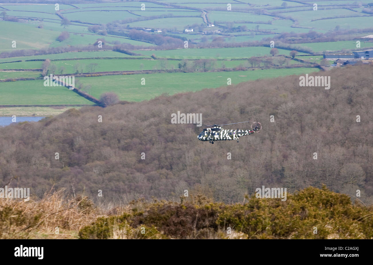 A Navy Sea King helicopter flying over Wimbleball Lake Exmoor National
