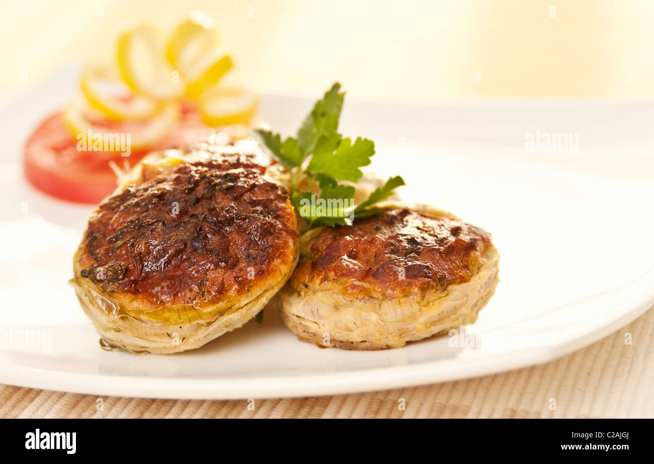 Stuffed artichokes with cheese, ham and bacon Stock Photo