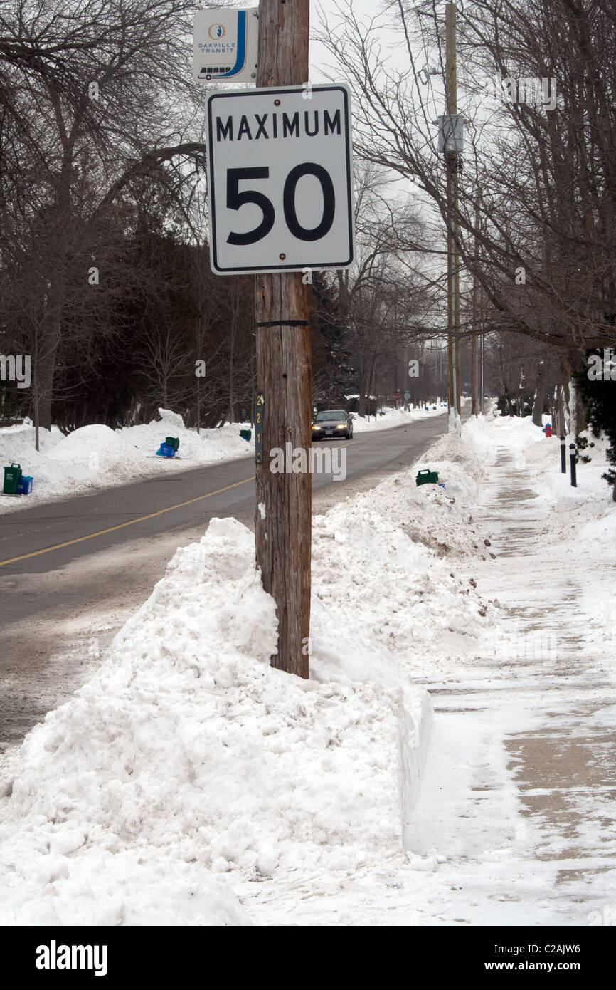 Maximum 50 speed limit sign on snowy street Stock Photo