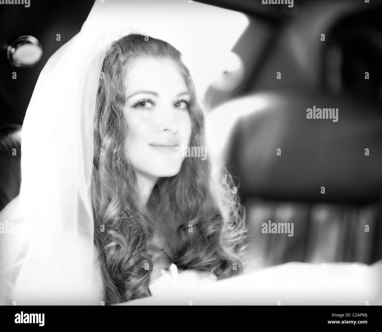 Young red hair bride in the limo on her way to the ceremony. Model release signed. Stock Photo