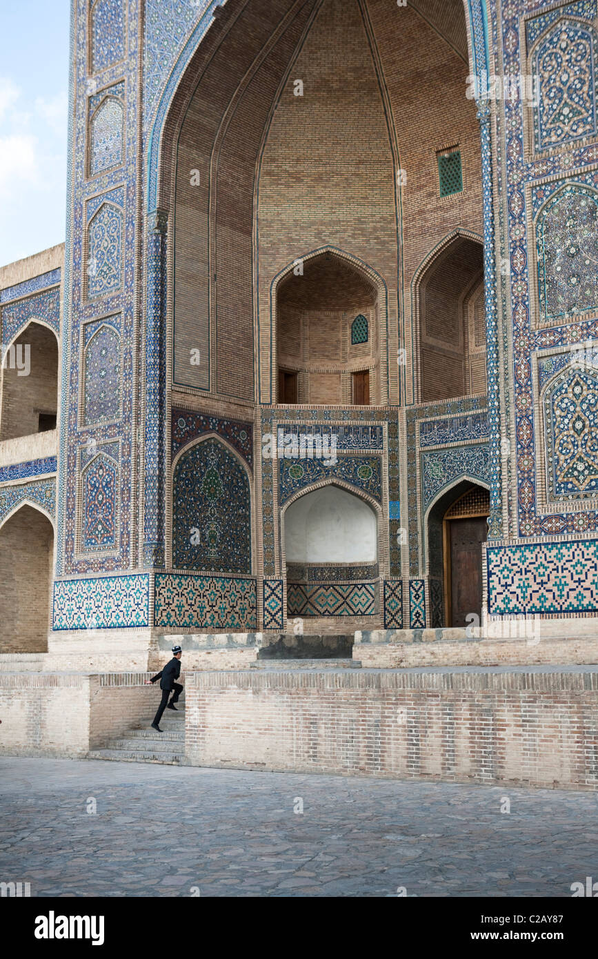 Uzbekistan, Bukhara, Mir-i Arab Madrasah, person hurring up the steps Stock Photo