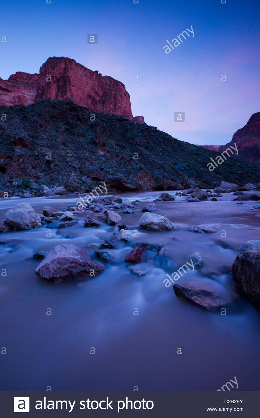 Colorado river rushing over stones at twilight Stock Photo - Alamy