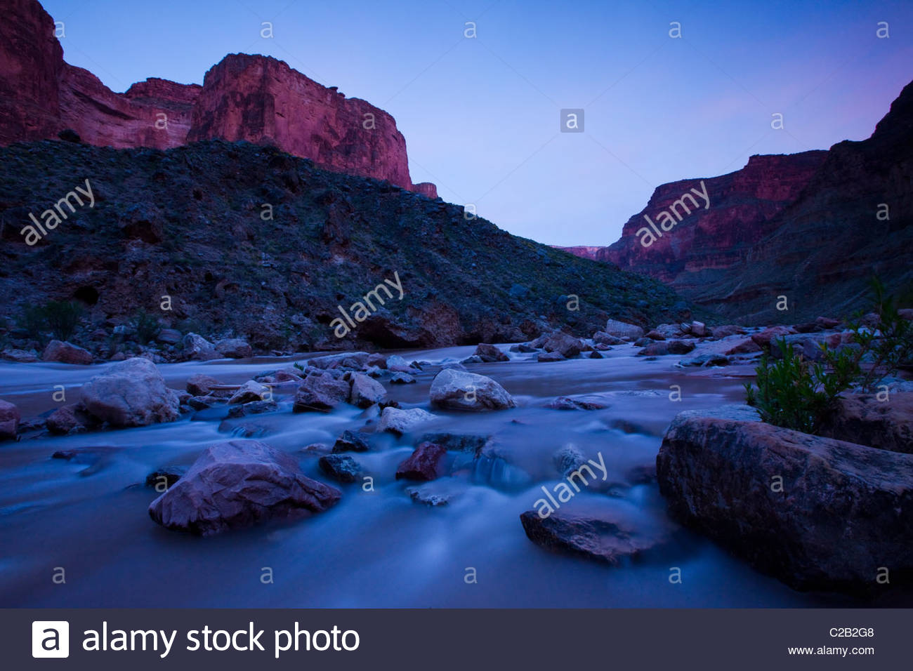 Colorado river rushing over stones at twilight Stock Photo - Alamy