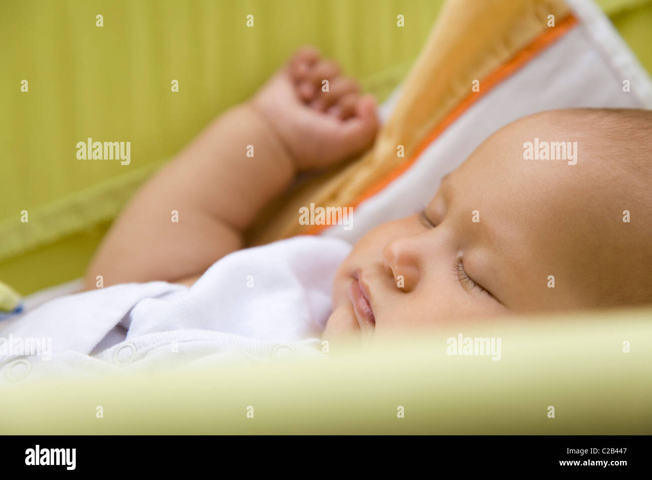 Baby sleeping in crib, side view Stock Photo Alamy