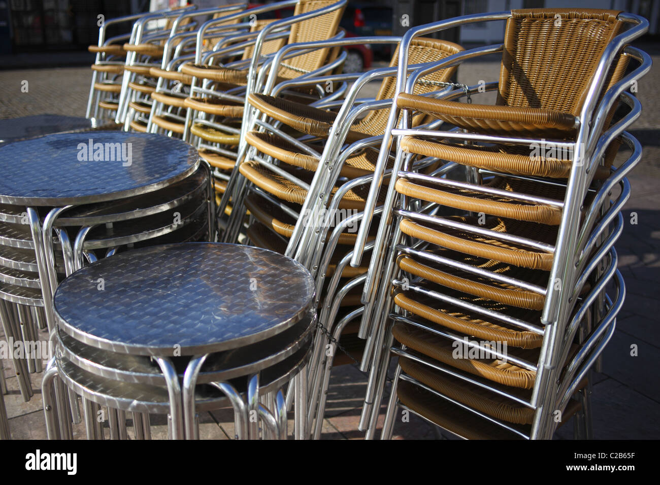 Stacked steel tables and chairs outside a restaurant Stock Photo Alamy