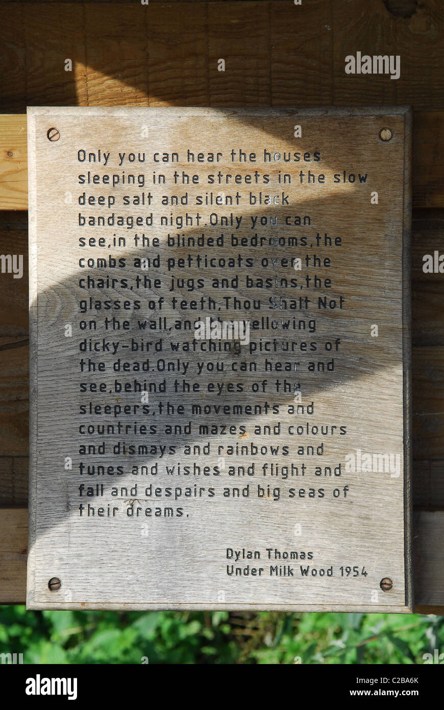 An extract from Dylan Thomas's play 'Under Milk Wood' displayed in a  shelter at Laugharne, Carmarthen, Dyfed, West Wales, United Stock Photo -  Alamy