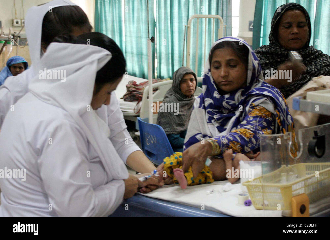 Nurse gives treatment to an infant child at a children hospital on ...