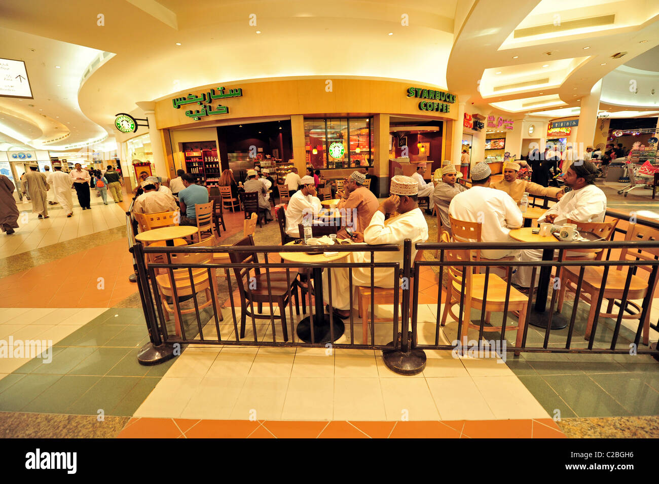 Oman, Muscat, group of people sitting in the cafe at the shopping mall Stock Photo