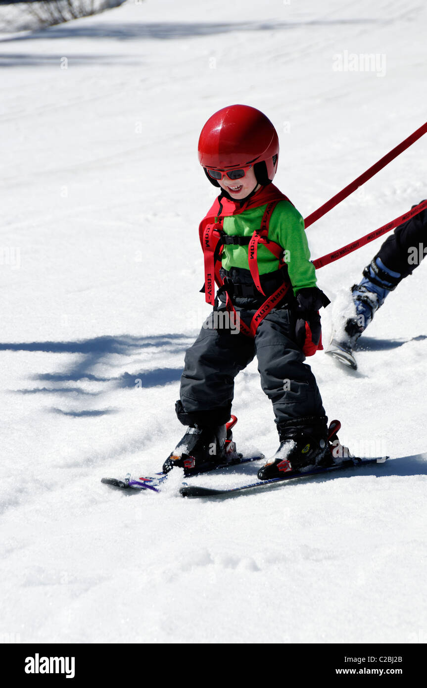 A young boy learning to ski on snow Stock Photo Alamy