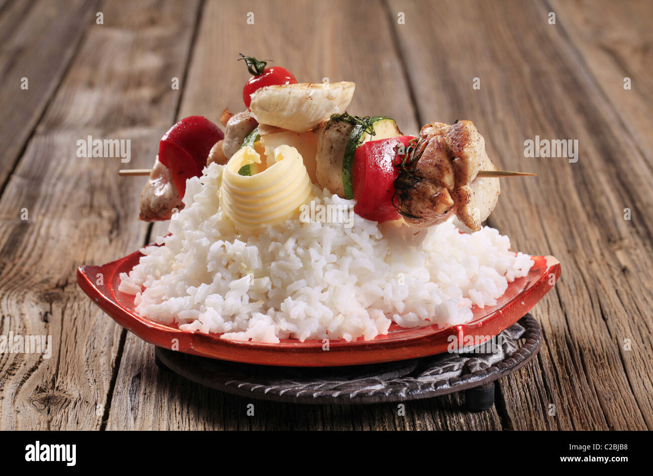 Chicken shish kebab on bed of white rice Stock Photo Alamy