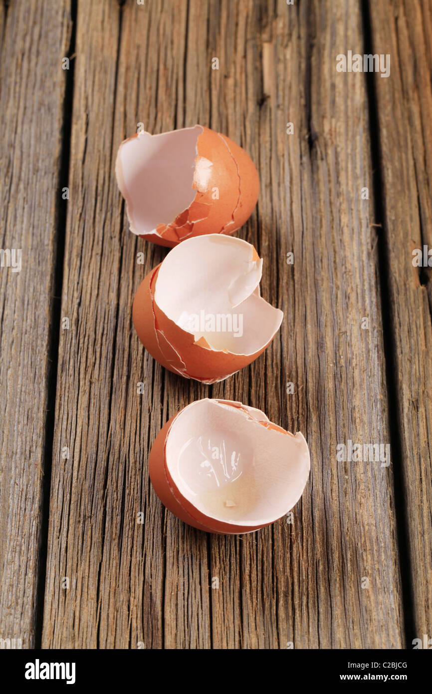 Empty brown egg shells on wood Stock Photo