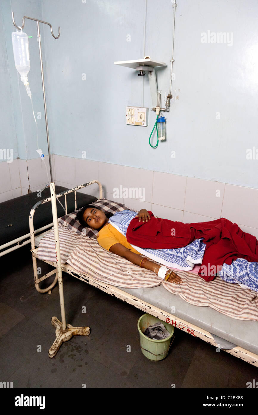 Female Indian patient lying on bed in an Indian Hospital. Sholapur Maharashtra India Stock Photo