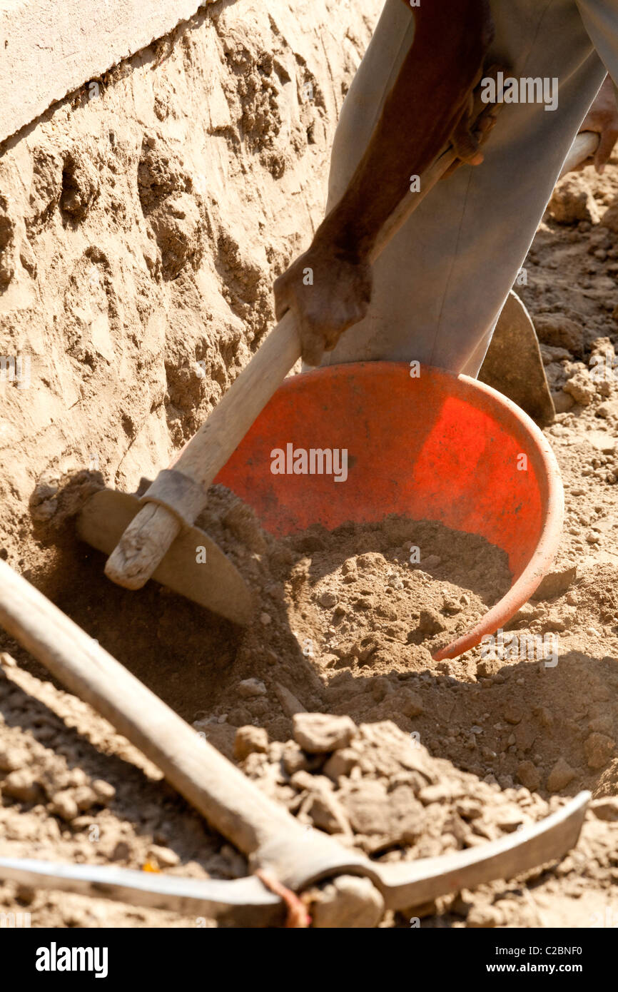 Laborer repairing a road in the village of Valsang Maharashtra India Stock Photo