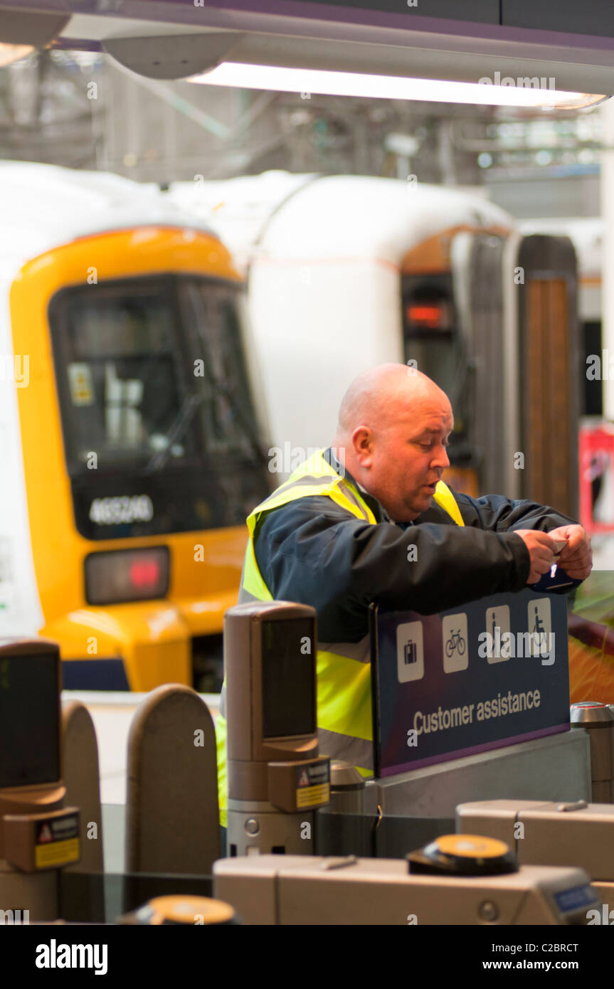 Network Rail employee checking tickets at Victoria Station, London Stock Photo Alamy