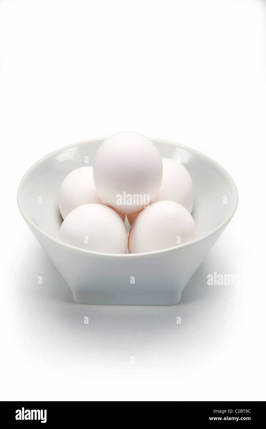 White eggs in white bowl on white Stock Photo