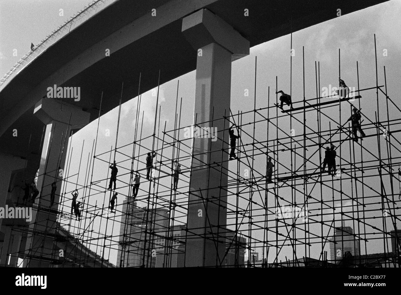 Workers on bamboo scaffolding in Shanghai, China. Stock Photo