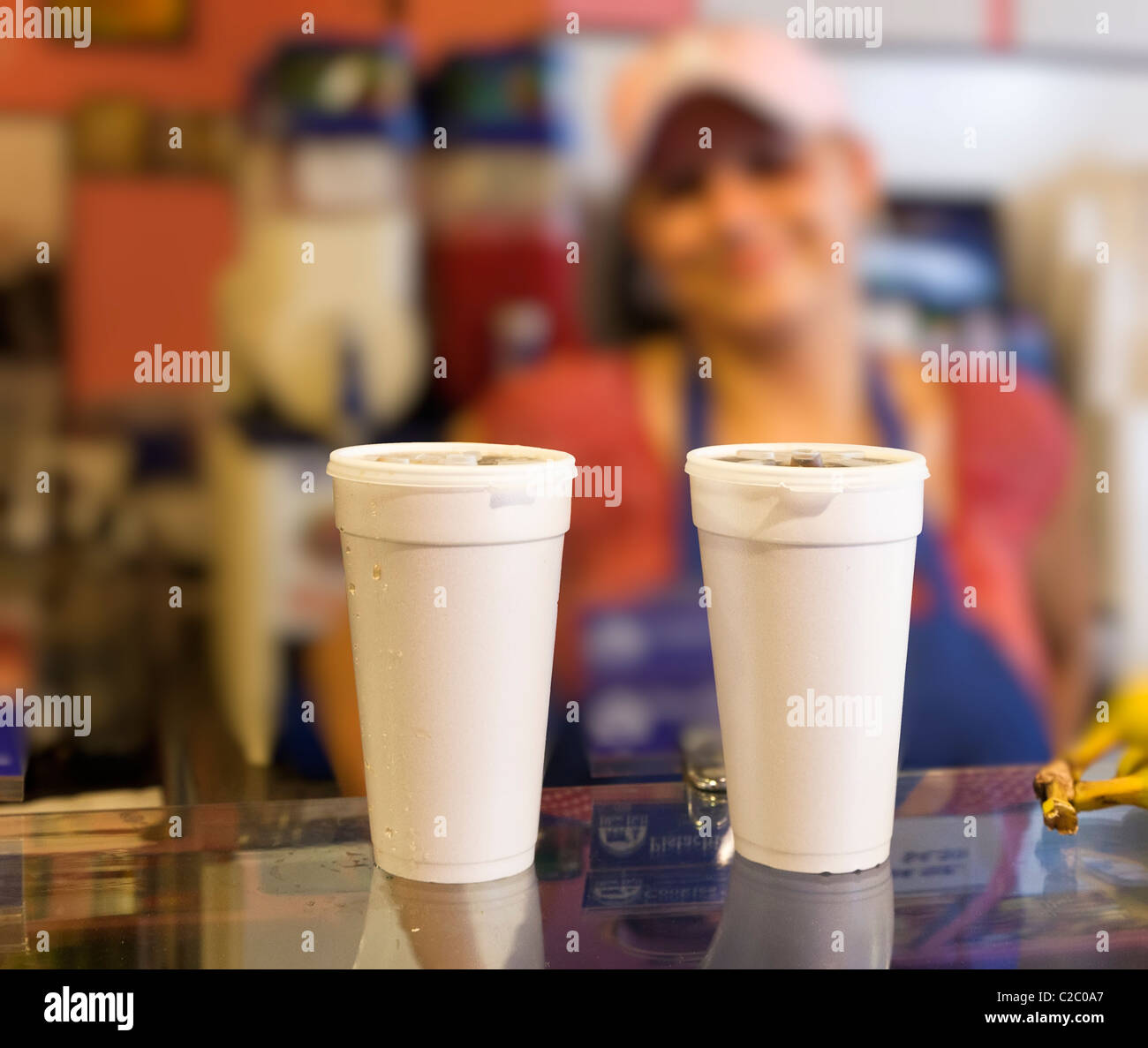 Smiling girl serving drinks over counter San Antonio Texas USA Stock Photo